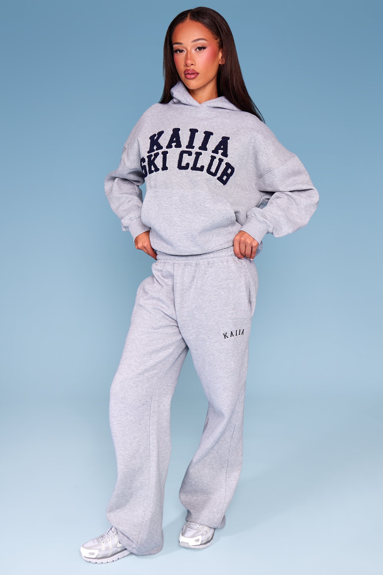 Mid grey marl wide leg joggers featuring a navy "KAIIA SKI CLUB" slogan, made from soft material with an elastic waistband and side pockets.