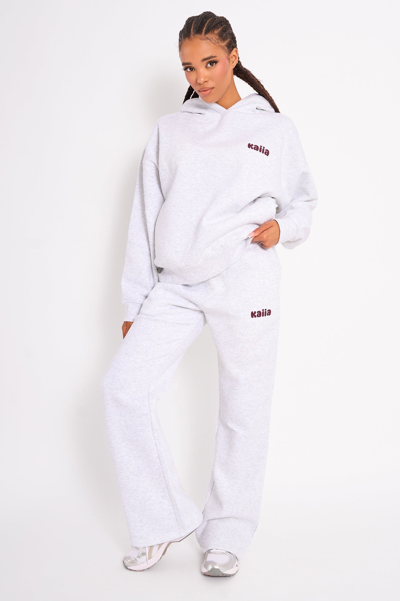 Light grey marl wide leg joggers with a relaxed fit, featuring a subtle plum logo on the left hip, made from soft, comfortable material.