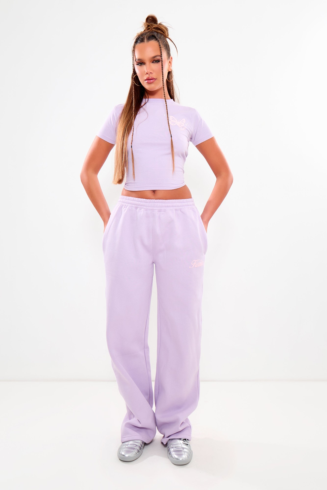 Wide leg joggers in lilac with a soft, cozy material, featuring side pockets and a subtle pink logo detail, paired with a matching lilac crop top.