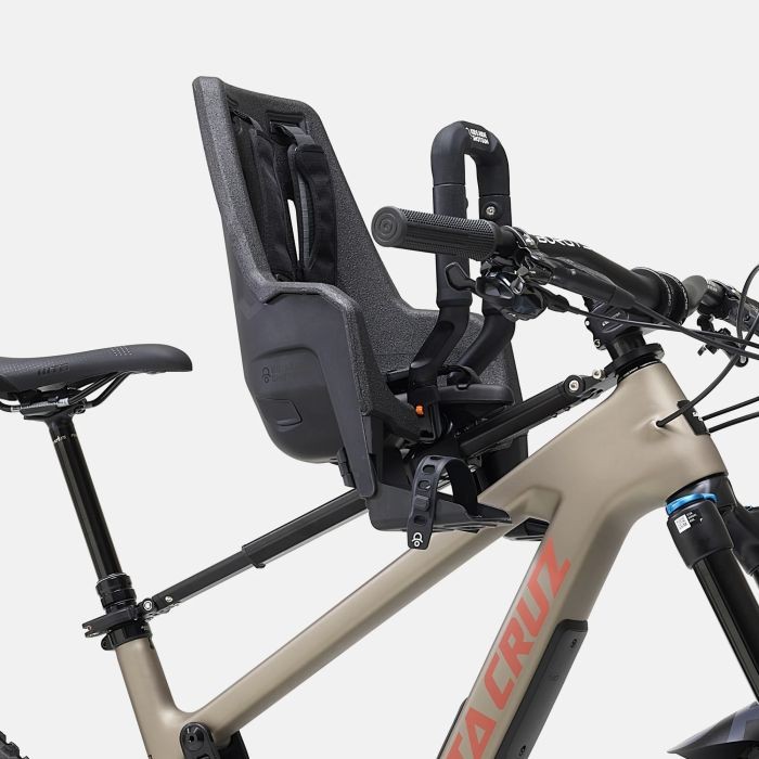 Black Kids Ride Shotgun Pro Evo child bike seat mounted on a bike frame, featuring a sturdy design, adjustable harness, and ergonomic support for young riders.