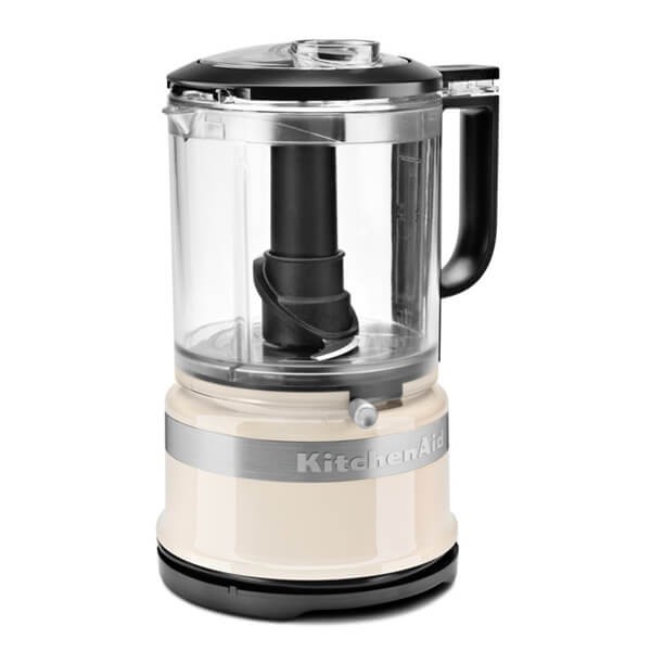 KitchenAid 5KFC0516BAC Mini Food Processor in almond cream, featuring a transparent bowl, black handle, and a sleek design with a stainless steel band.