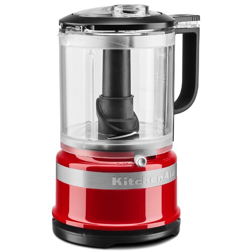 Bright red mini food chopper with a transparent bowl, black lid, and handle, featuring a stainless steel band and a single button for operation.