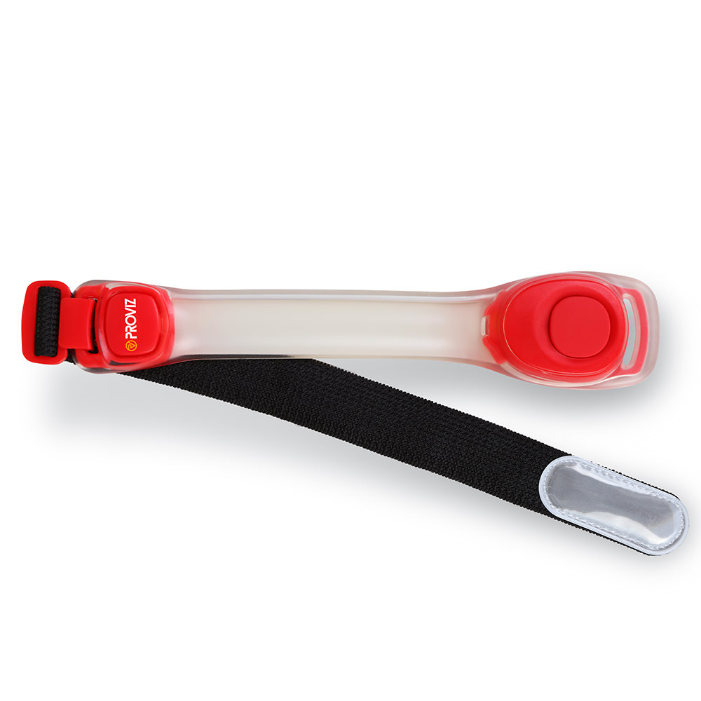 Red LED armband by Proviz featuring a clear plastic body, adjustable black strap, and a prominent red button for easy operation.