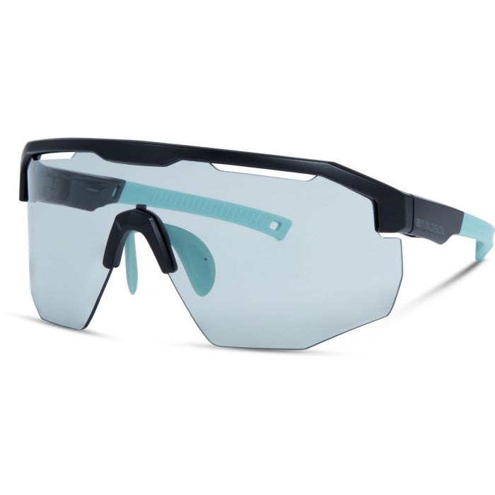 Madison Cipher sunglasses feature a matte black frame with a bold design and photochromic lenses that transition from clear to tinted, complemented by aqua accents on the temples.
