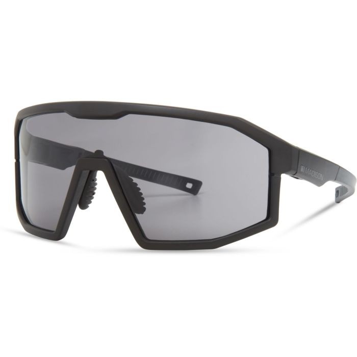 Madison Enigma sunglasses in a sleek matte black finish with black mirror lenses, featuring a bold geometric frame and adjustable nose pads for a secure fit.