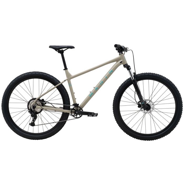 Tan and turquoise Marin Bolinas Ridge 2 hardtail mountain bike, featuring a lightweight frame, 29-inch wheels, and rugged tires, designed for off-road performance.