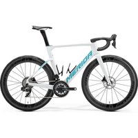 White Merida Reacto 9000 road bike with aerodynamic frame, black wheels, and teal accents.