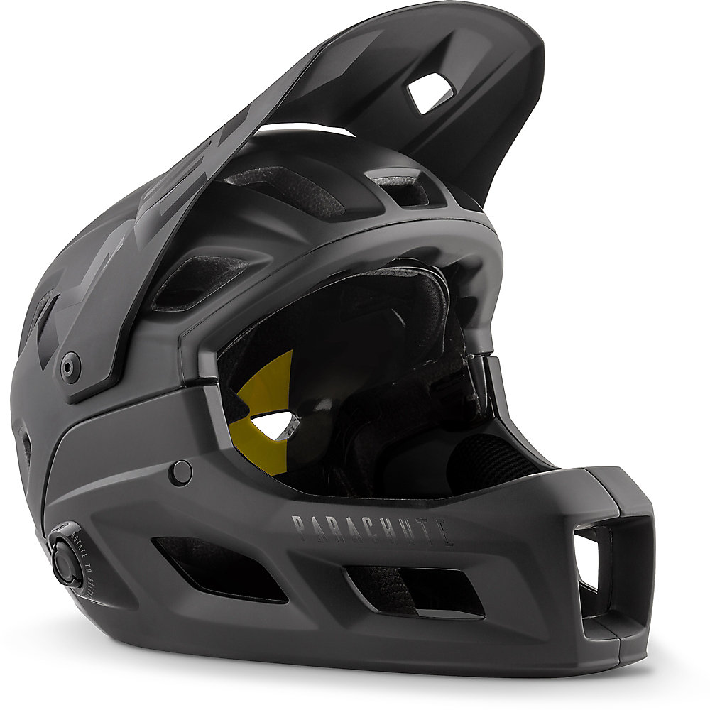 Small matte glossy black MET Parachute MCR MIPS helmet featuring a full-face design, ventilation ports, and a chin guard for enhanced protection.