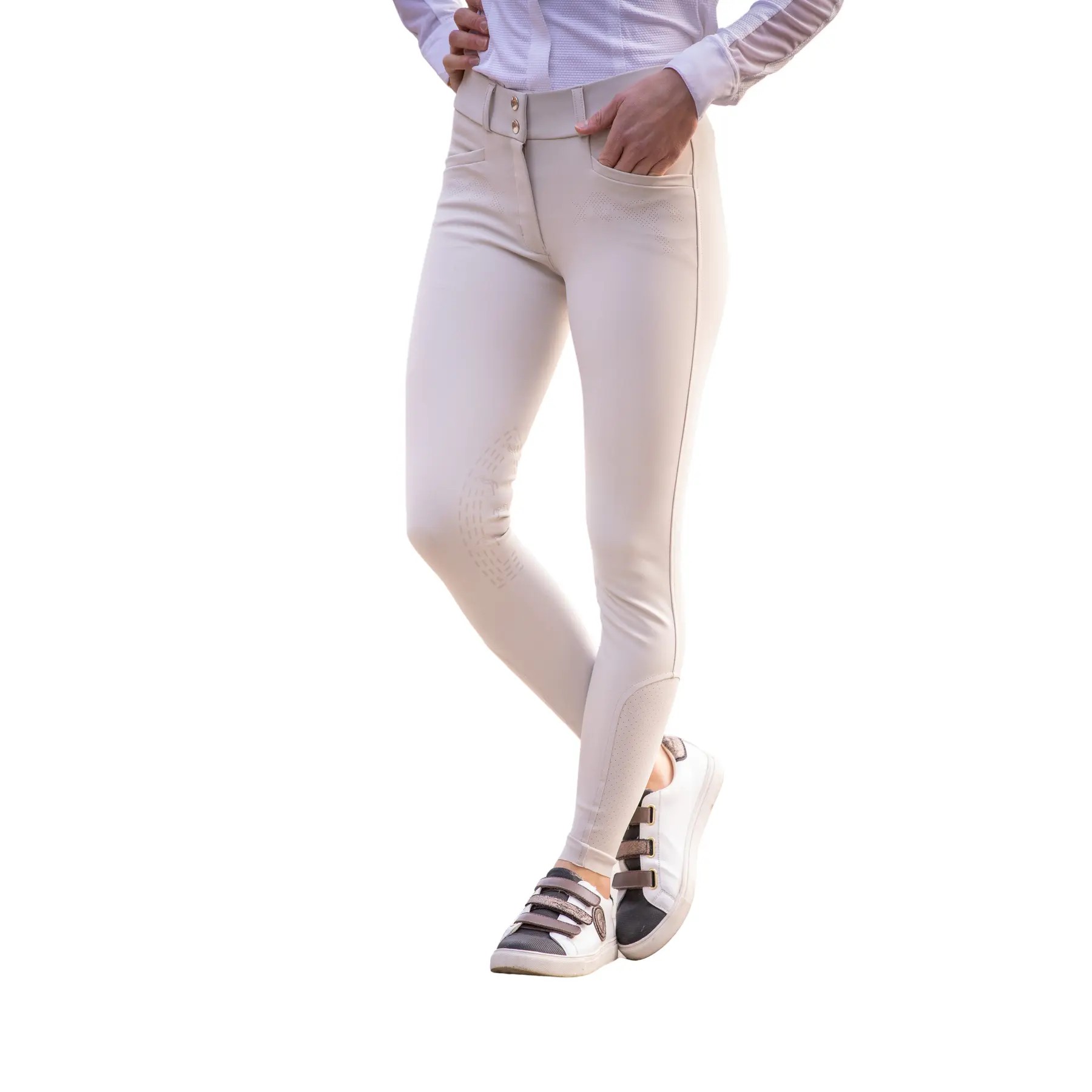 Beige equestrian riding pants for women by Pénélope, featuring a mid grip design, slim fit, and a high waistband, paired with sporty white shoes.