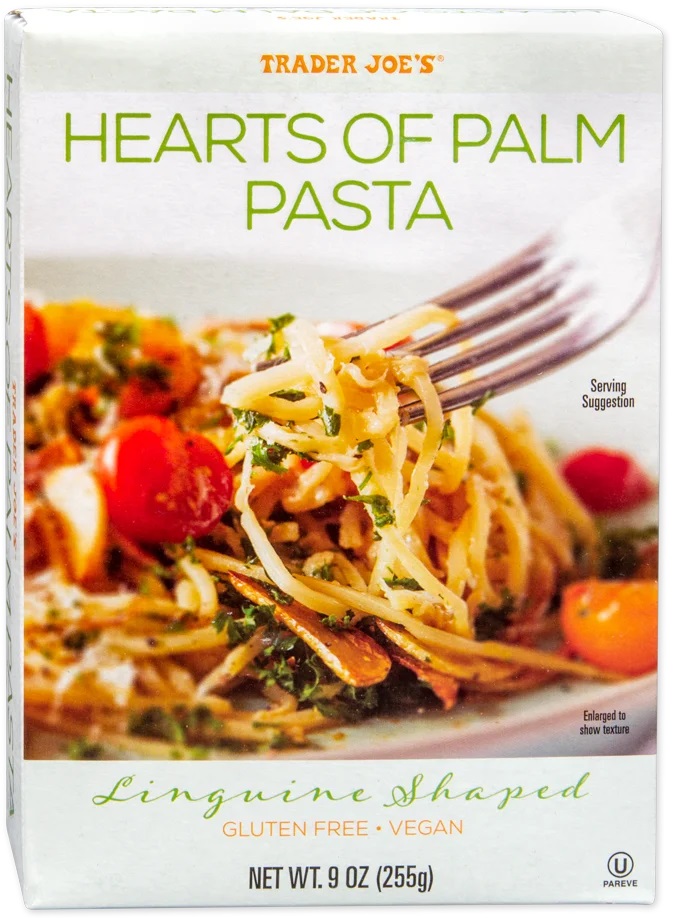 Trader Joe's Hearts of Palm Pasta in a 9 oz box features a vibrant design with green text, a serving suggestion of linguine-shaped pasta, and colorful cherry tomatoes and herbs.