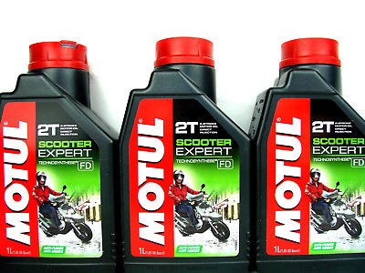 Black plastic bottle of MOTUL 105881 Engine Oil, 1L capacity, featuring a red cap and label with green and red accents, labeled "Scooter Expert" and "2T Synthetic Oil."
