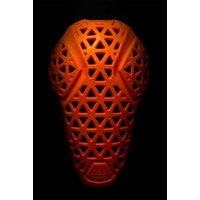 Black MT500 D3O® Lite knee pads with orange geometric pattern and flexible protective shell.