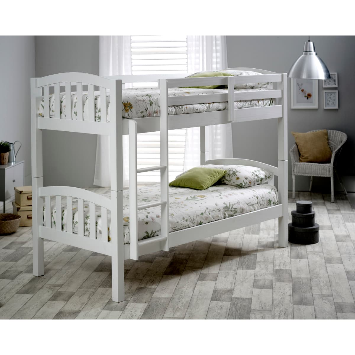 Solid wood white bunk bed with a slatted design, featuring two mattresses with floral bedding, a ladder for access, and a modern room setting with natural light.
