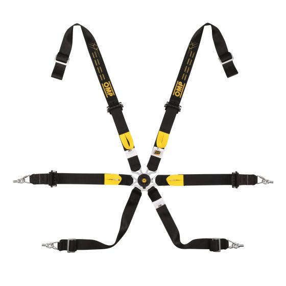 Black 6-point harness with yellow accents, featuring adjustable straps, metal buckles, and a central release mechanism, designed for motorsport safety.