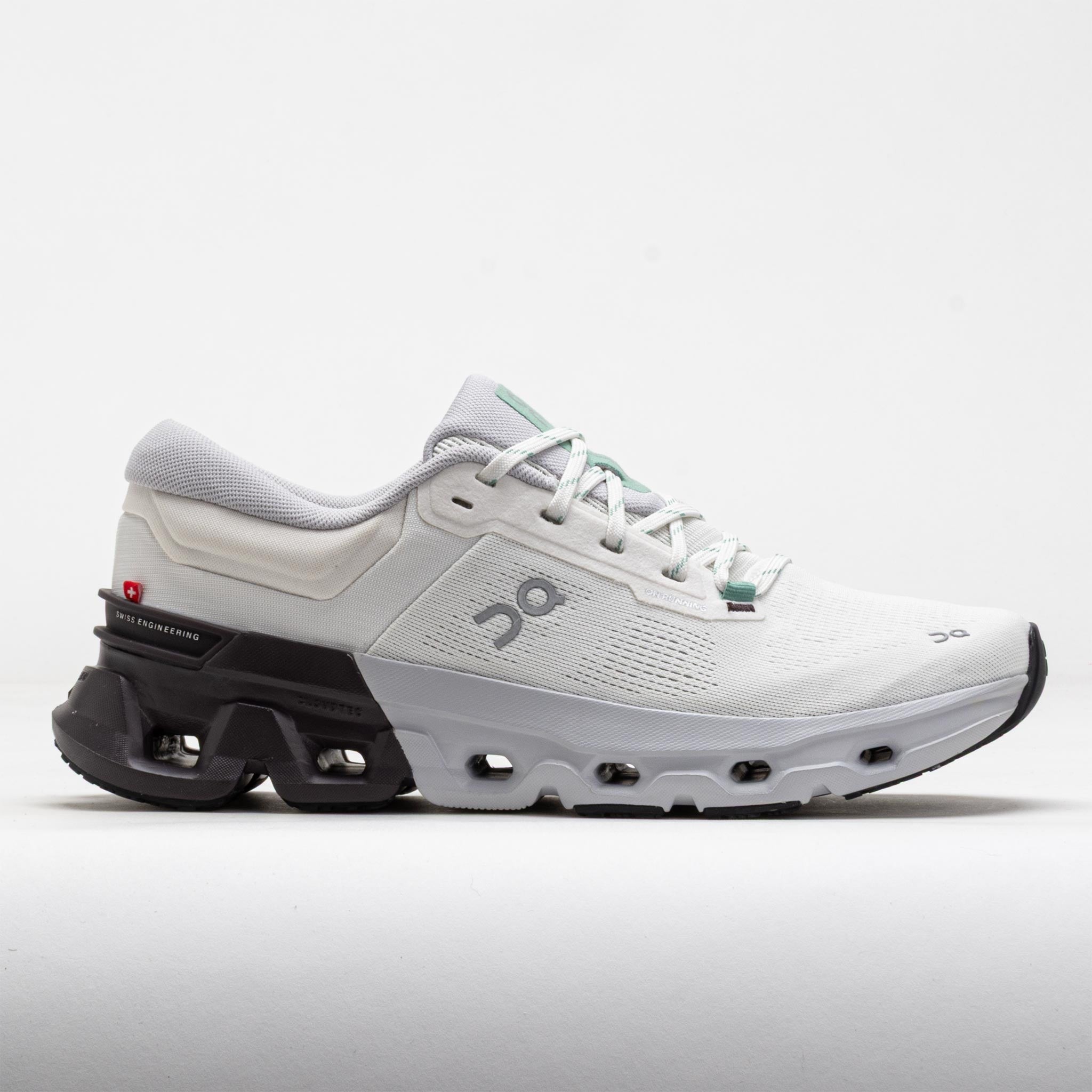 White and grey running shoes with a sleek design, featuring a breathable mesh upper, cushioned sole, and distinctive black heel support, size 43.