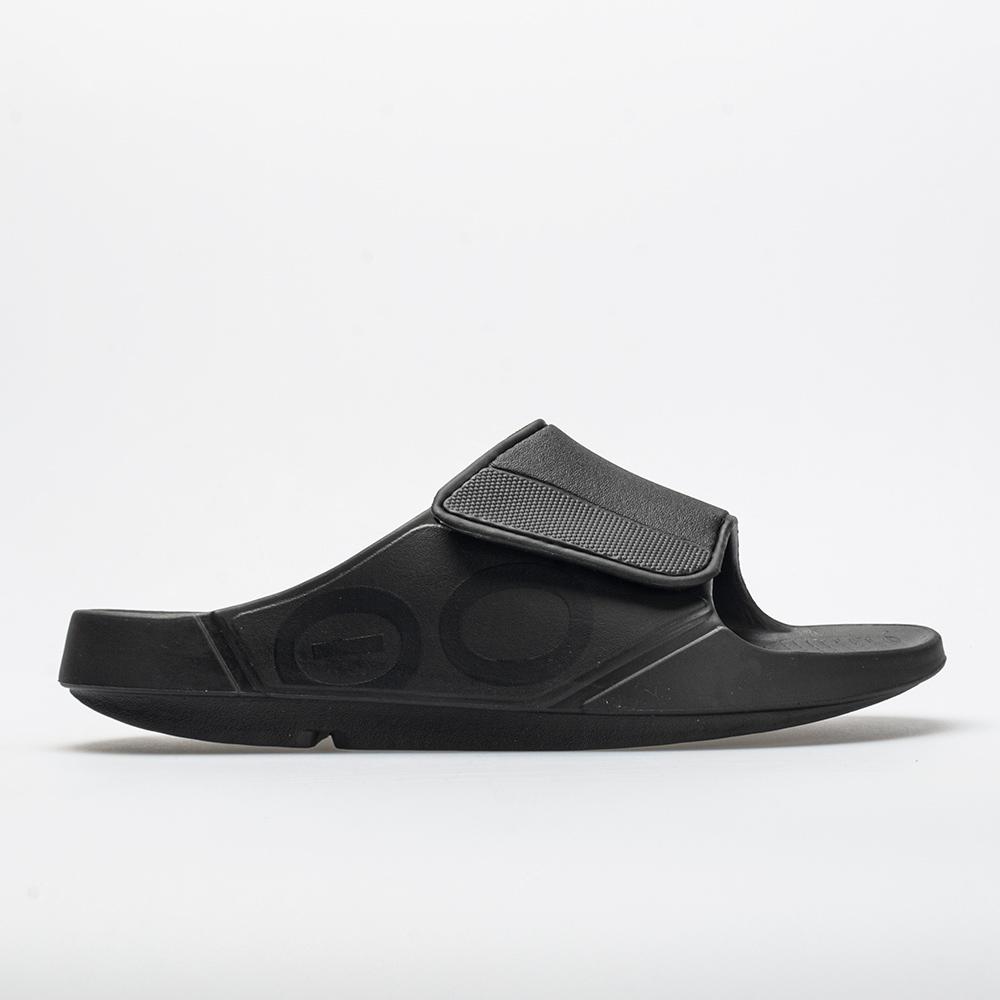 Black unisex sandal featuring a flexible design, adjustable strap, and cushioned footbed, ideal for comfort and support, with a sleek, minimalist aesthetic.