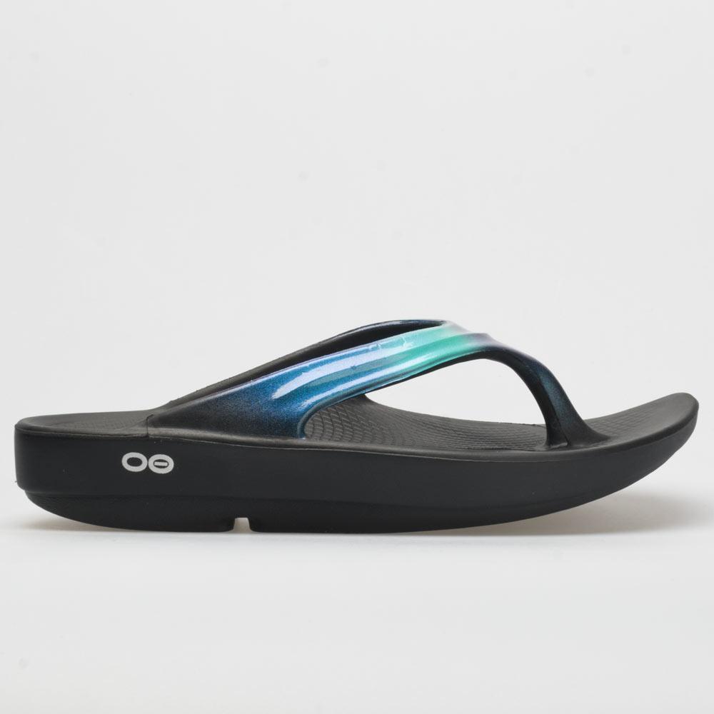 Oofos Oolala Luxe Recovery Sandals in Atlantis color feature a sleek black base with a glossy blue-green strap, designed for comfort and recovery.