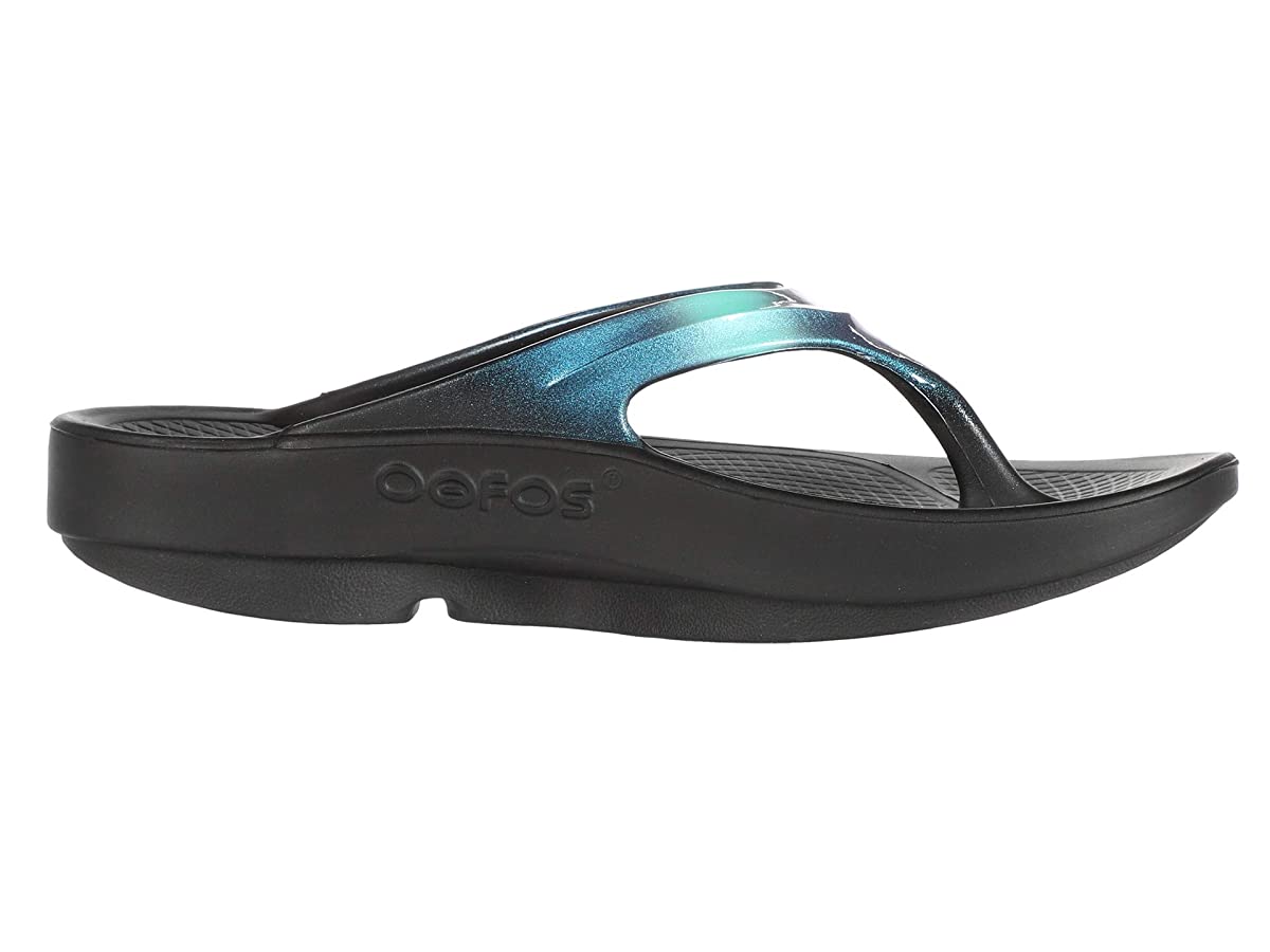 Oofos Oolala Luxe Recovery Sandals in Atlantis color feature a shiny teal strap and a black foam sole, designed for comfort and recovery. Size 9.
