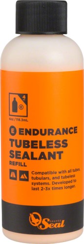 Orange Seal Endurance Sealant Refill in a 4oz bottle, featuring a bright orange label with black text, designed for tubeless tire systems and compatible with various tubes.