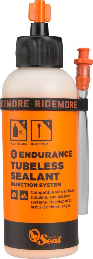 Orange Seal Endurance Sealant in a 4oz orange bottle with a black cap and a clear applicator injector attached, designed for tubeless tire systems.