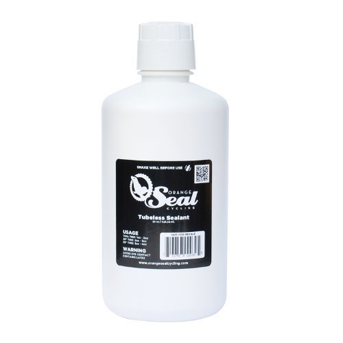 White 32oz bottle of Orange Seal tubeless sealant featuring a black label with orange text, usage instructions, and a QR code for more information.