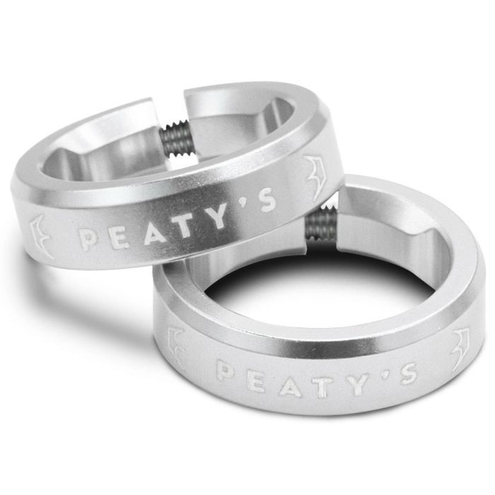 Silver aluminum grip lock rings by Peaty's, featuring engraved branding, designed for secure attachment and easy adjustment.