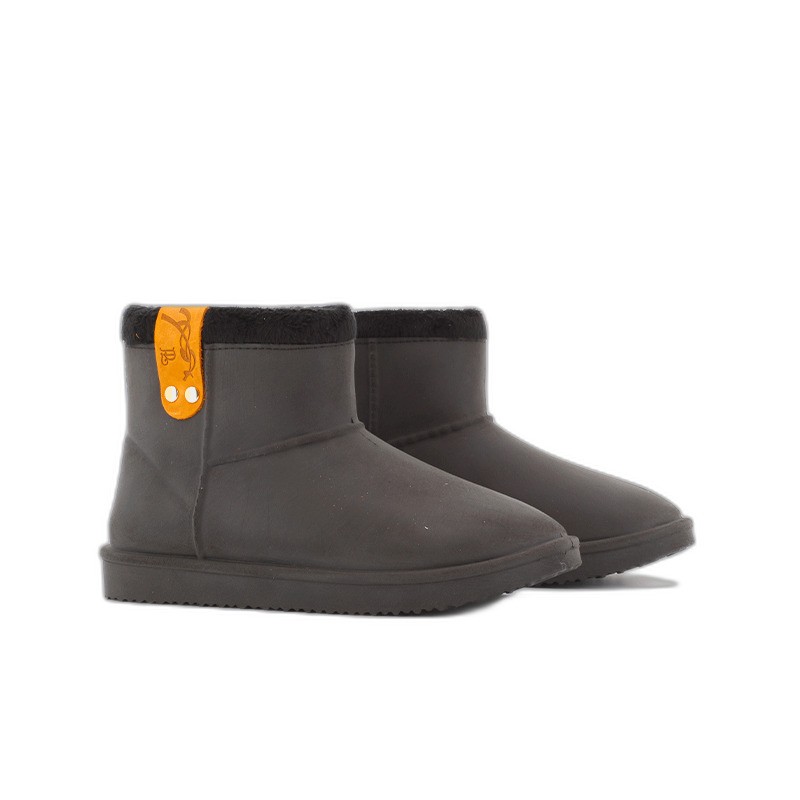 Black riding boots with a soft fur lining, featuring an orange strap with button detail on the side, designed for comfort and style.