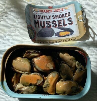 A blue tin can labeled "Trader Joe's Lightly Smoked Mussels" contains several plump, golden-brown mussels in dark sauce, with a shiny metal lid partially opened.