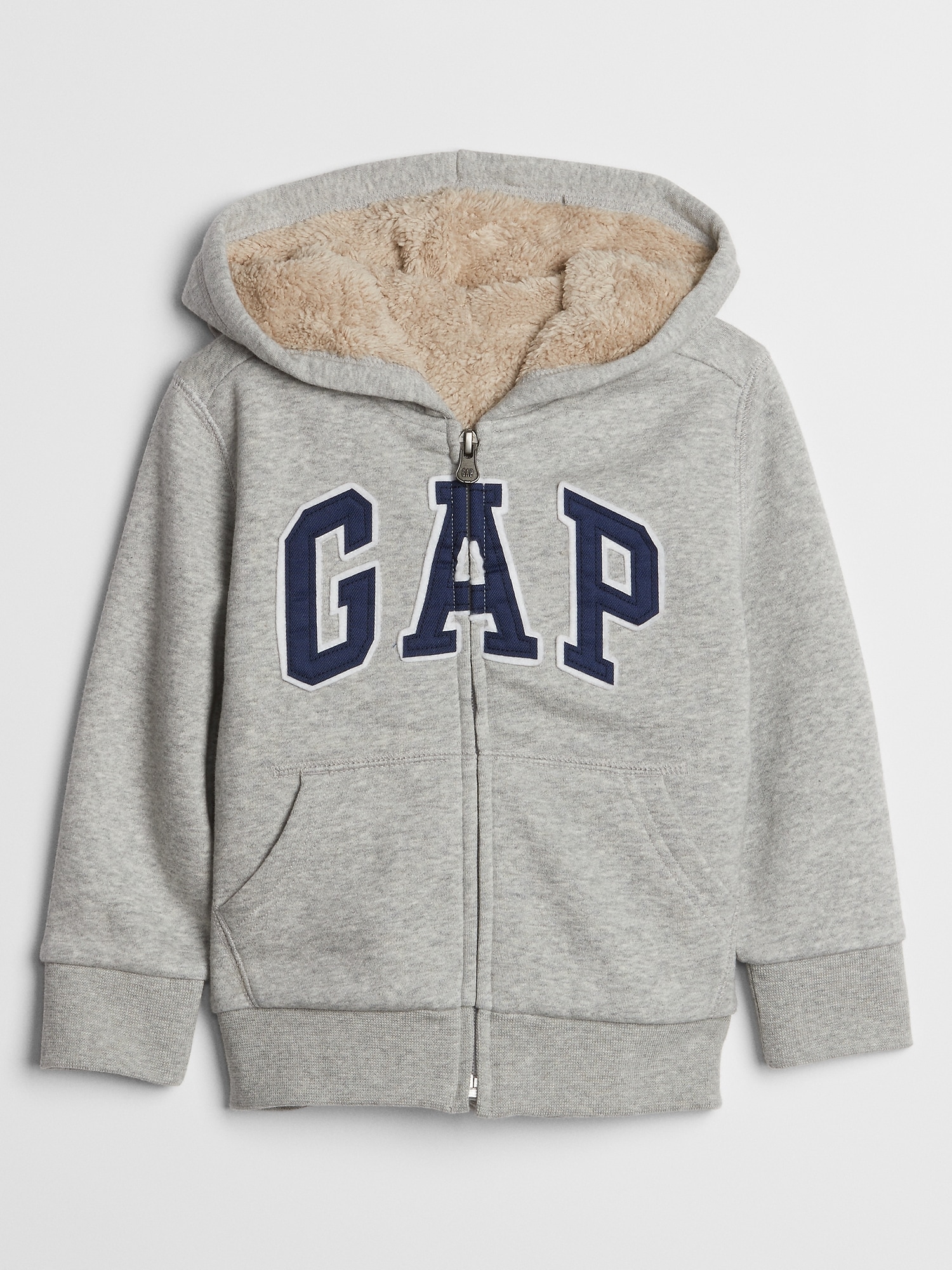 Gray zip-up hoodie with a soft, beige fleece lining, featuring a large navy "GAP" logo on the front and two front pockets.