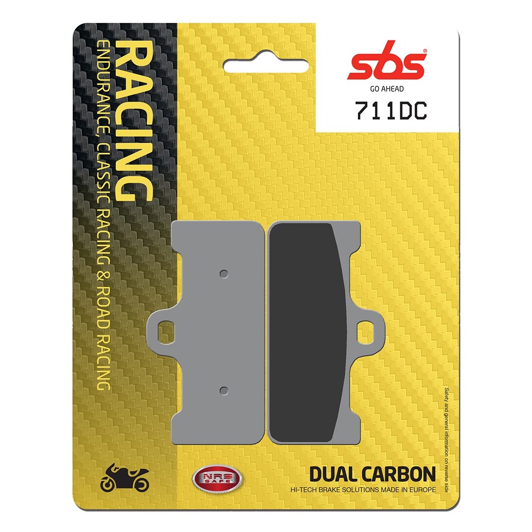 Grey brake pads on a yellow and black packaging, featuring "SBS Go Ahead 711DC" and "Dual Carbon" labels, designed for endurance and classic racing.
