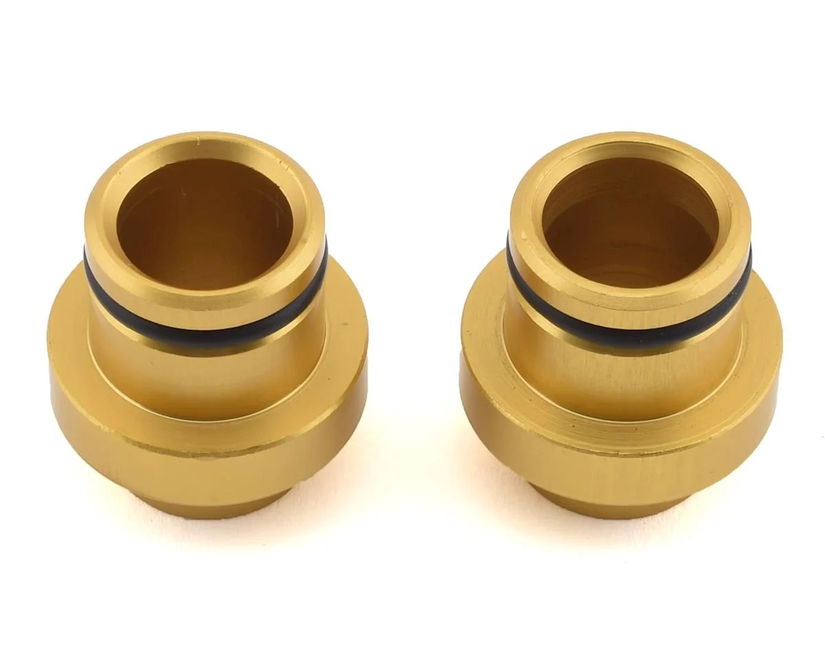 Gold anodized aluminum thru axle plugs with black rubber O-rings, designed for 15x110mm axles, featuring a sleek, durable finish and precise engineering for a secure fit.