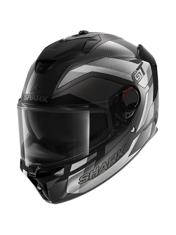 Matt carbon silver motorcycle helmet with aerodynamic design, featuring a tinted visor, ventilation system, and prominent "SHARK" branding on the sides. Size XL.