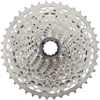 Silver Shimano Deore 11-speed cassette with 11-42T gear range and intricate sprocket design.