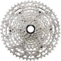 Silver Shimano Deore CS-M6100 12-speed cassette with 10-51T gear range, intricate sprocket design.