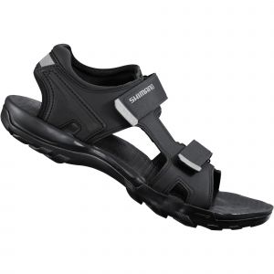 Black Shimano SD5 SPD sandals feature adjustable straps, a cushioned footbed, and a durable rubber sole, designed for comfort and performance in cycling. Size 39.