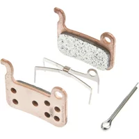 Shimano XTR M965 metal disc brake pads with copper backing, perforated design, and included spring clip.