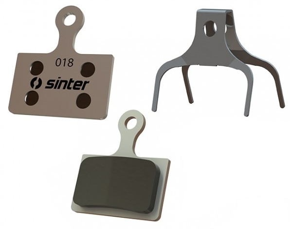 Sinter Green S2032 organic disc brake pads in grey with a distinctive shape, featuring the Sinter logo and model number 018, designed for Shimano Type K.