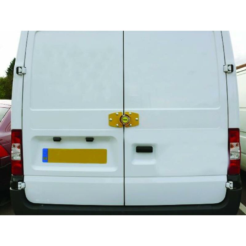 A gold and green STOPLOCK HG19900 immobilizer is secured on the rear doors of a white van, featuring a robust design for enhanced security.