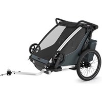 Dark slate grey Thule Chariot Cross 2 double bike trailer with large wheels and a sleek aerodynamic design.