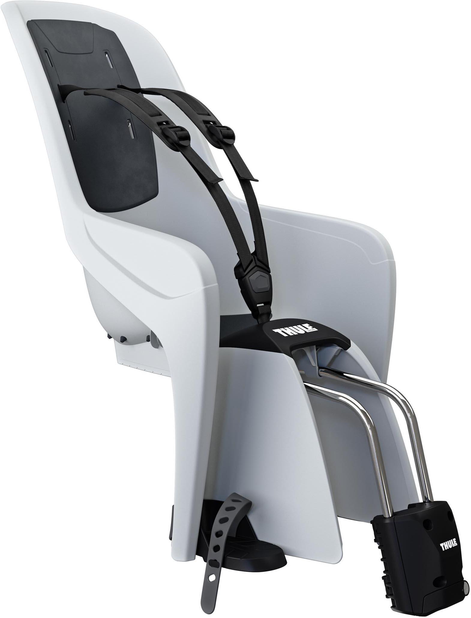 Light grey Thule child bike seat with black harness, adjustable footrests, and sturdy metal support bars.