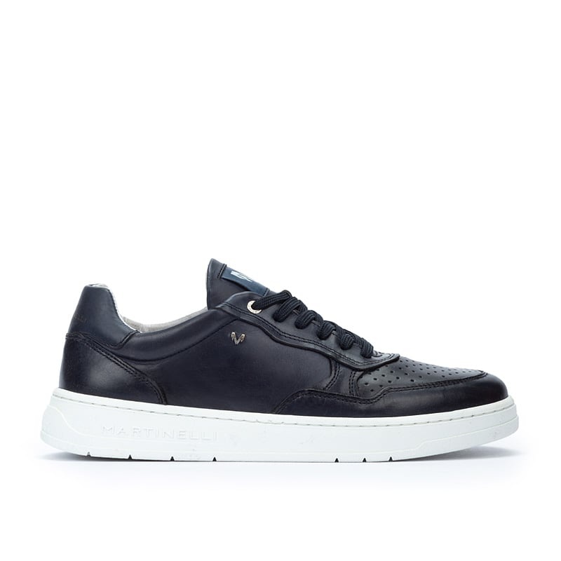 Black leather trainers with perforated detailing, white rubber sole, and subtle Martinelli branding on the side.