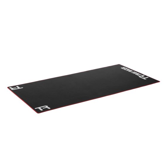 Black neoprene floor mat with red edges, featuring the Trak Racer logo in white at both ends, designed for racing sim rigs to provide stability and protection.