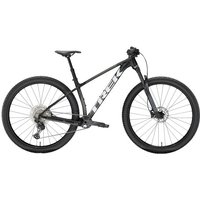 Black Trek Procaliber 6 mountain bike, hardtail frame, 29-inch wheels, front suspension, and disc brakes.