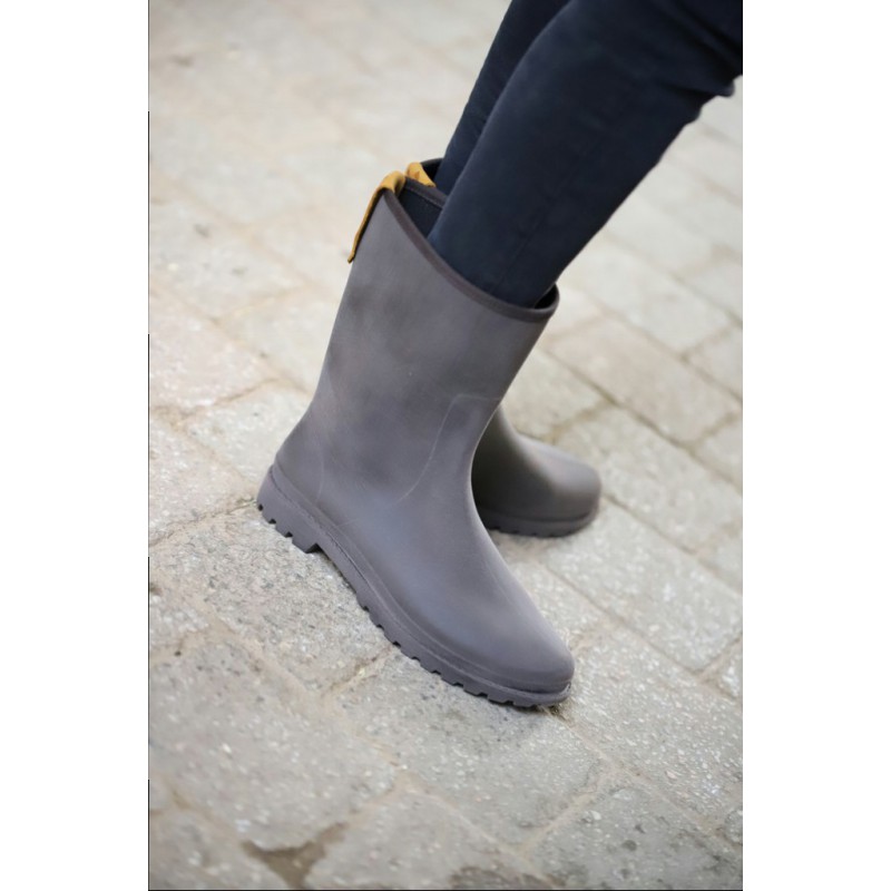 Stylish gray women's riding boots with a smooth rubber finish, featuring a sturdy sole and a subtle pull tab for easy wear.