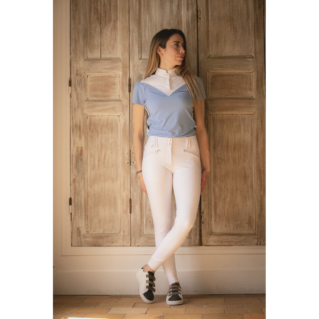Women's Penelope Rocky riding trousers in white, featuring a sleek design, front pockets, and a comfortable fit, paired with a light blue top and stylish sneakers.