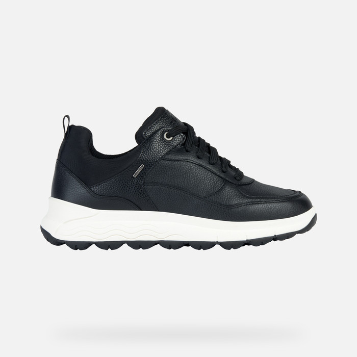 Black leather sneaker with a textured finish, featuring a white sole, lace-up front, and padded collar, designed for comfort and style, size 35.