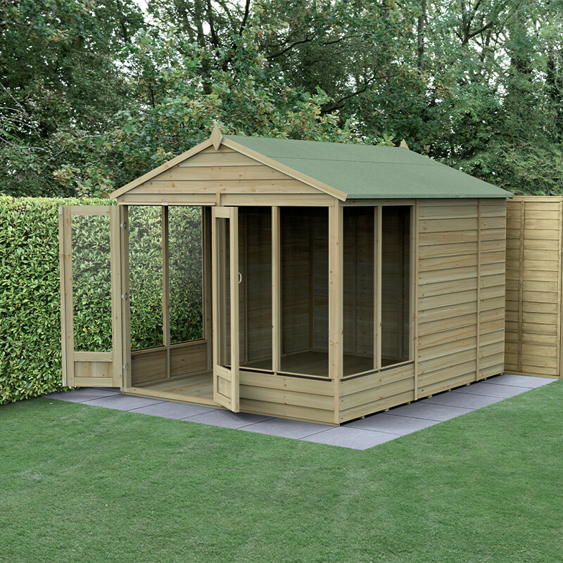 A wooden summer house with a green apex roof, double doors, and large windows, set in a garden with grass and hedges, featuring a 25-year guarantee from Forest Garden.