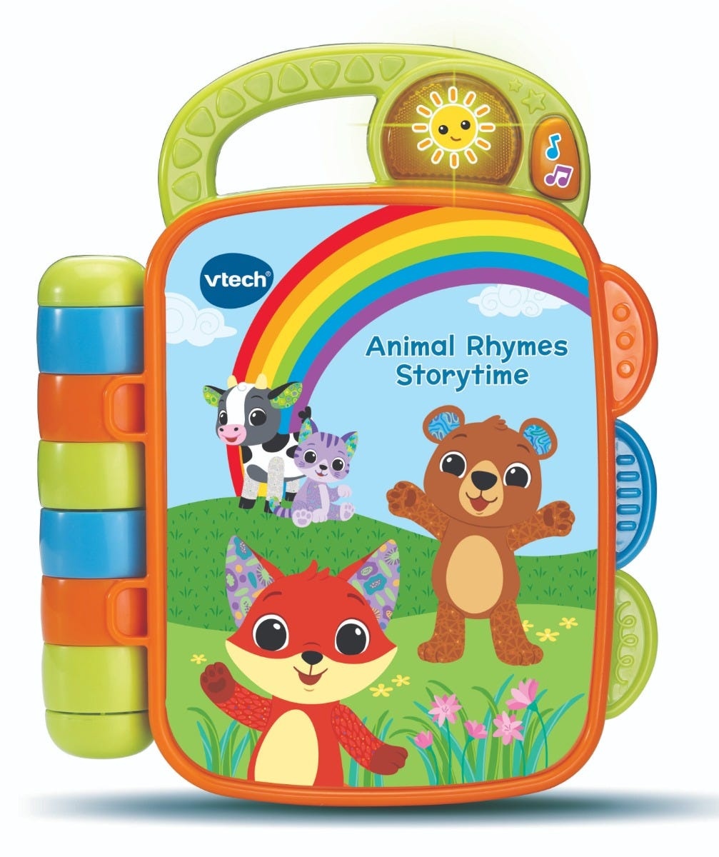 Colorful interactive storybook with a green handle, featuring a fox, bear, cow, and cat, set against a rainbow background, with buttons on the side for sounds and music.