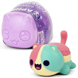 Purple capsule packaging with a smiling cat face, alongside a colorful squishy figure resembling a cat with pastel green, pink, and yellow sections.