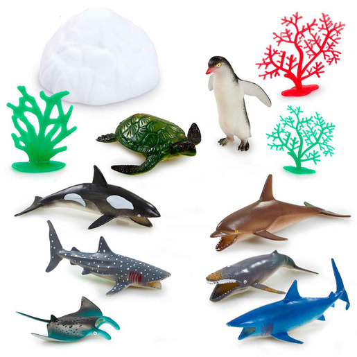 Colorful ocean-themed toy set featuring a white iceberg, green coral, and various sea creatures including a turtle, penguin, orca, and multiple sharks in vibrant colors.